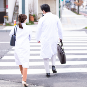 白衣を着た男女が歩く後ろ姿